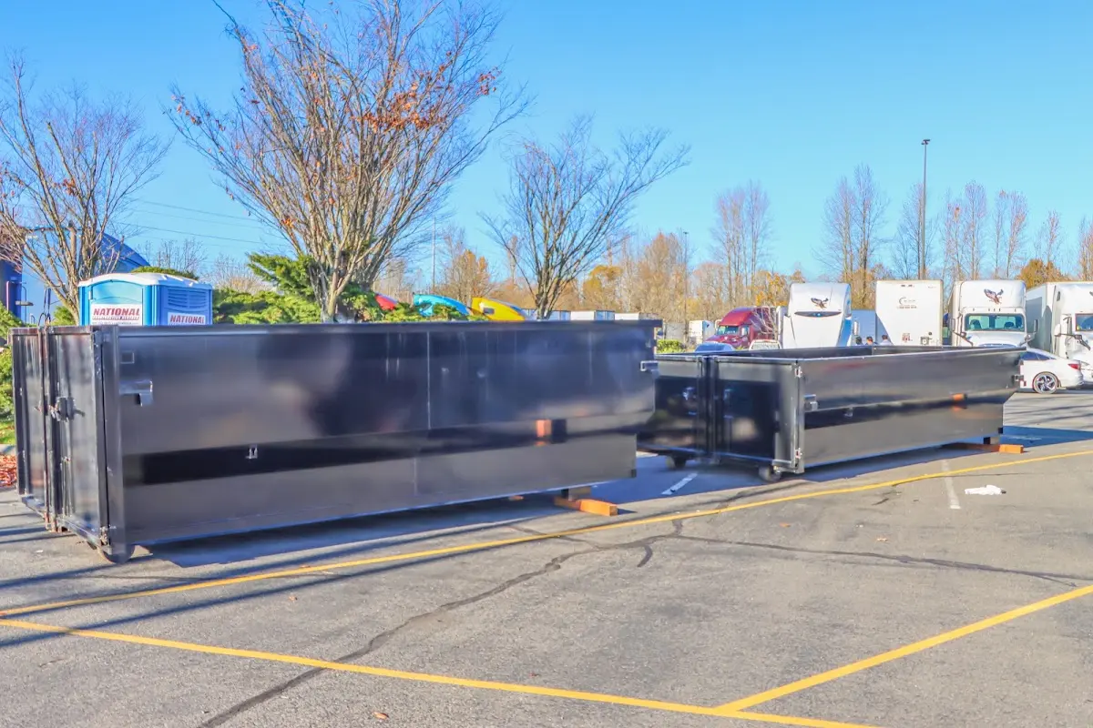 Professional dumpster rental service with roll-off container on residential driveway in Gibsonton